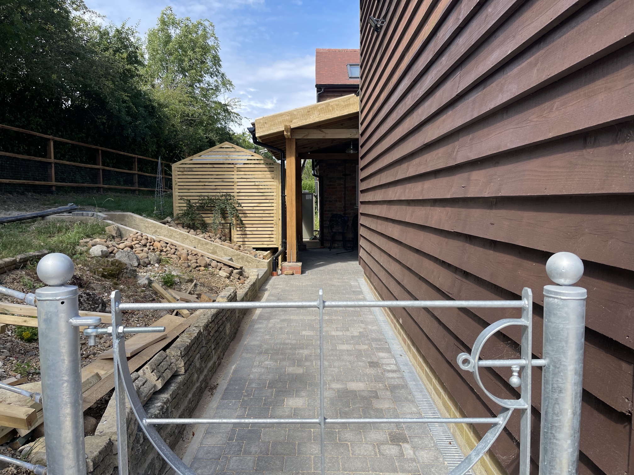 Oak-framed car port with new block-paved pathway, galvanised gate and timber slatted screen