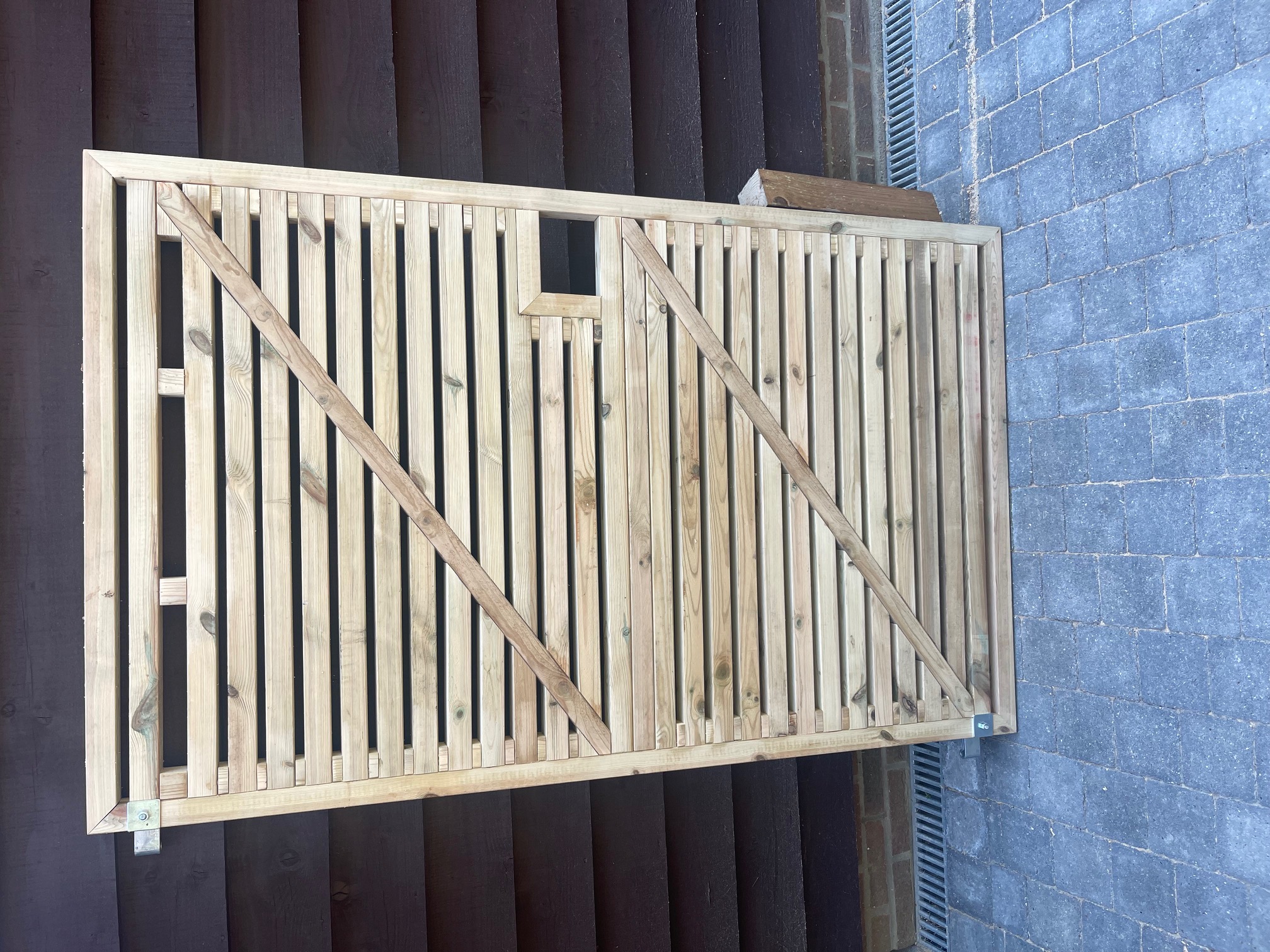 Handmade timber slatted garden gate with diagonal bracing